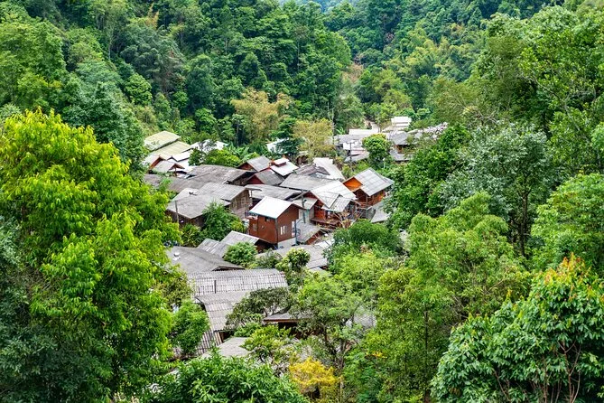 High-angle view of Mae Kampong houses packed into a forested mountain valley