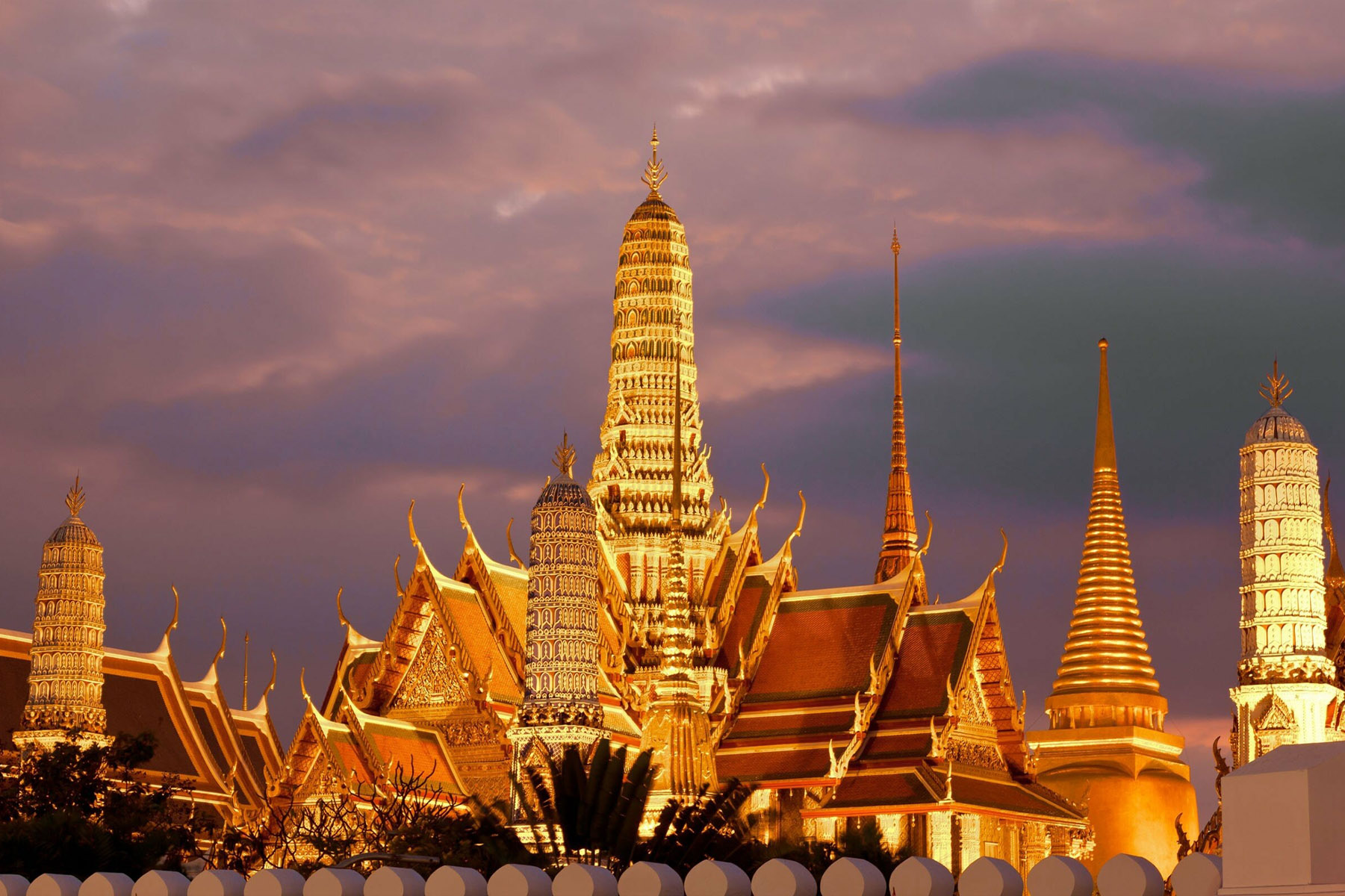 Golden spires of the Grand Palace at dusk