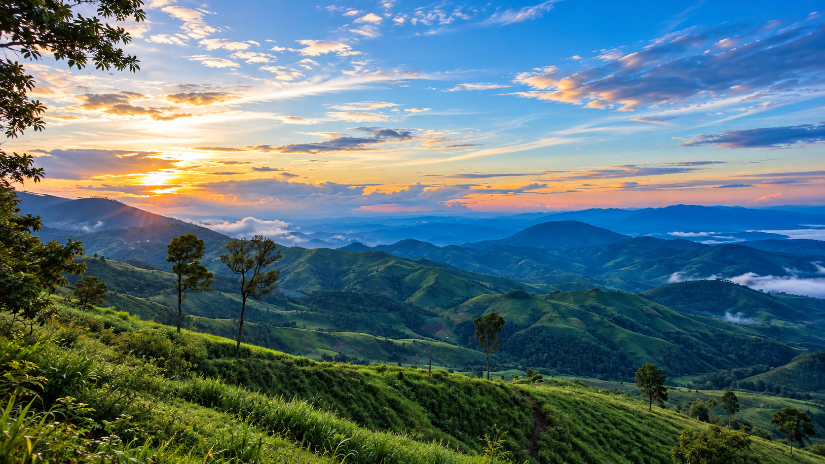 Sunrise over layered green ridges and valley mist at Khun Khan National Park, Samoeng, Chiang Mai