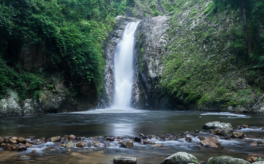 Chae Son Waterfall cascading into a forest pool in Chae Son National Park, Lampang
