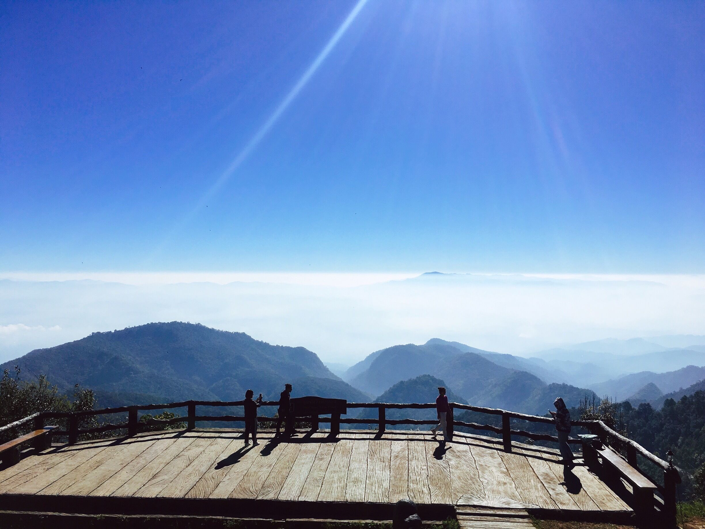 Wooden viewpoint deck above mountain ridges and mist at Doi Pha Hom Pok National Park