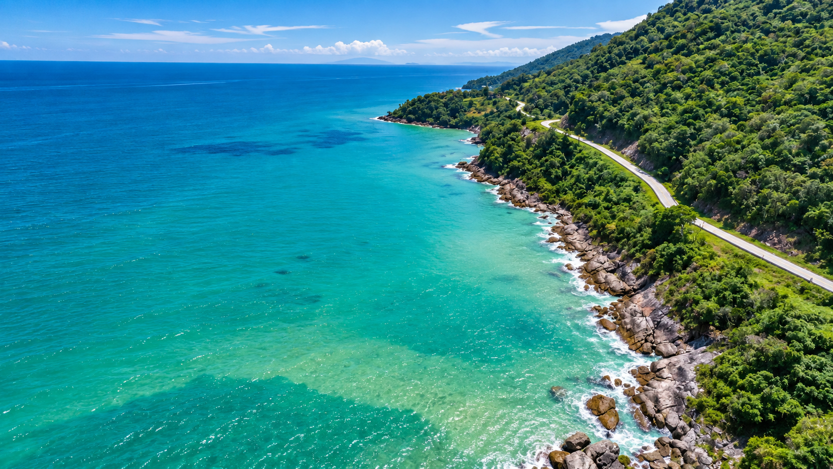Forested coastal road above turquoise Gulf water at Hat Khanom–Mu Ko Thale Tai