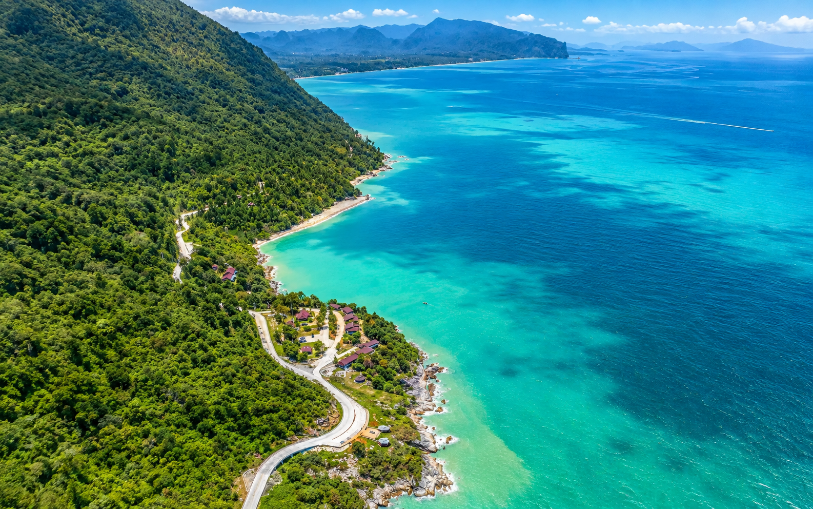 Winding mountain road above turquoise bays on the Khanom slow coast