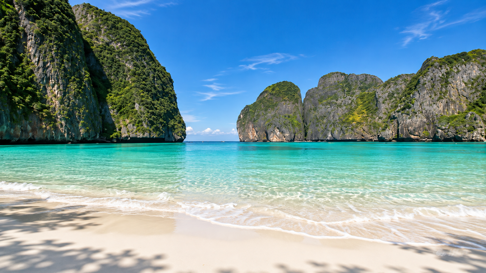 White sand and turquoise water framed by limestone cliffs at Maya Bay on Phi Phi Leh
