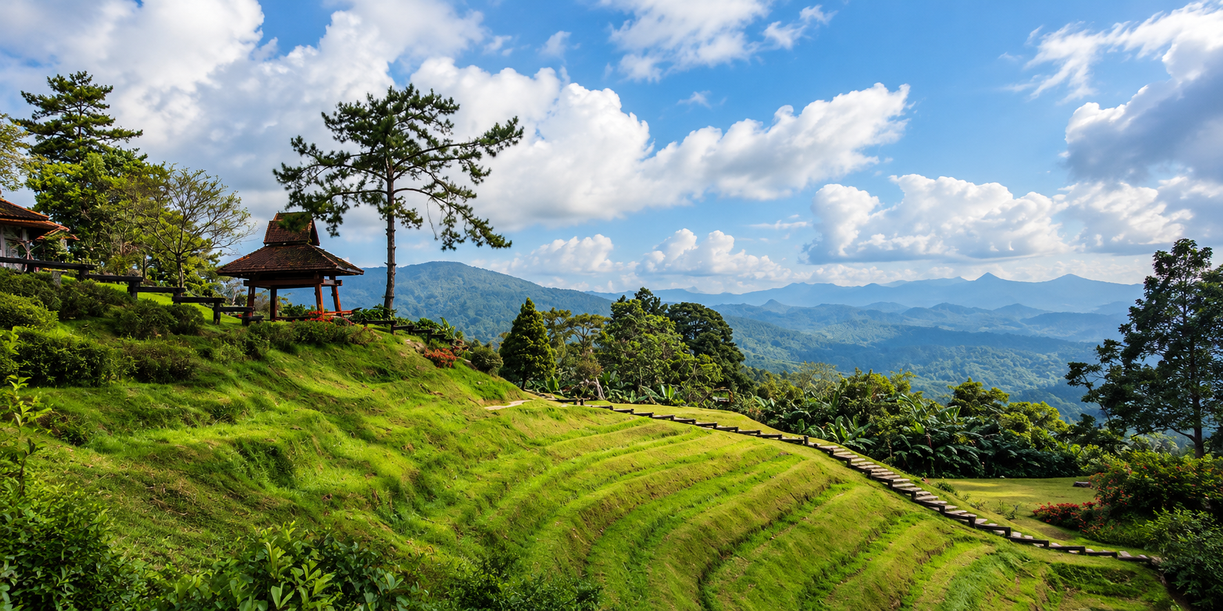 Pine trees, a wooden pavilion and terraced lawns looking across the mountain ranges of Huai Nam Dang