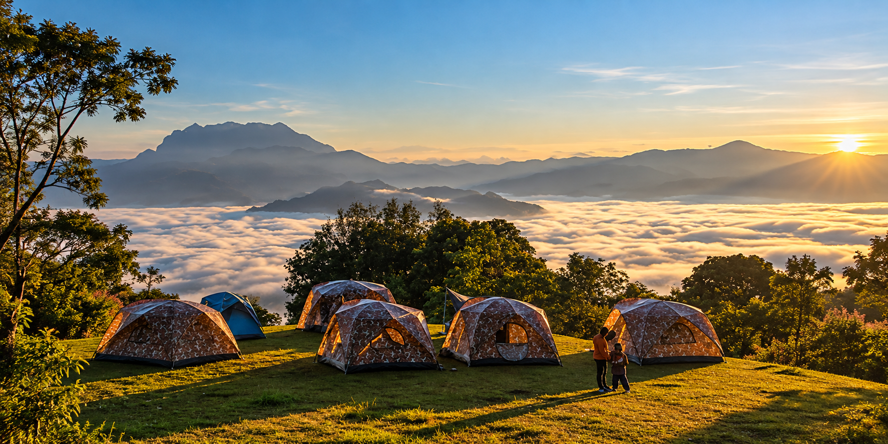 Tents on a highland meadow above a sea of mist at sunrise in Huai Nam Dang National Park