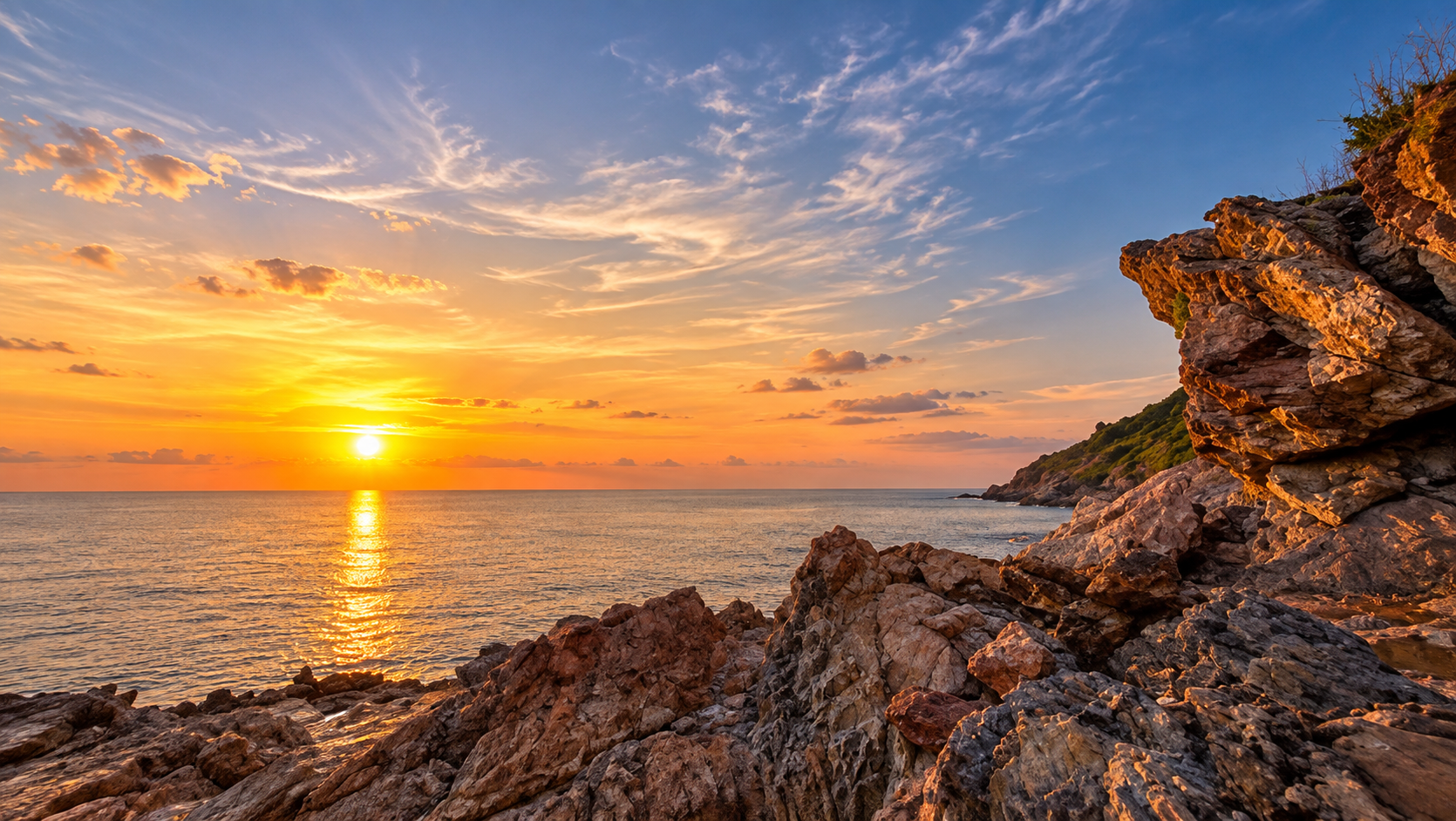 Sunset over the Gulf of Thailand from the rocky granite headland of Khao Laem Ya, Rayong