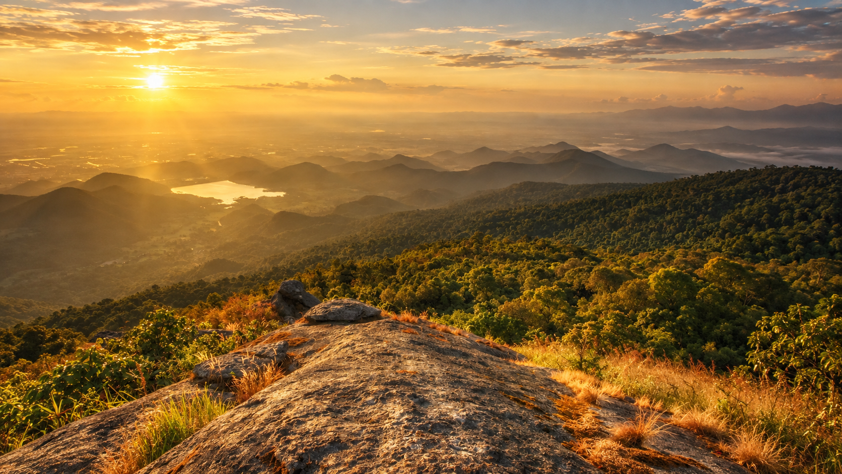 Sunrise over forested ridges from a rocky summit in Khao Luang National Park, Nakhon Si Thammarat