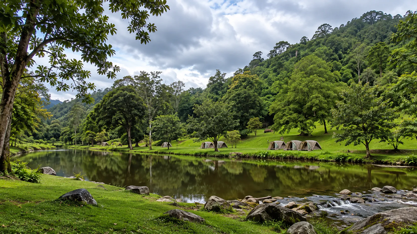 Tents beside a forest stream and still water at Khlong Wang Chao National Park, Kamphaeng Phet