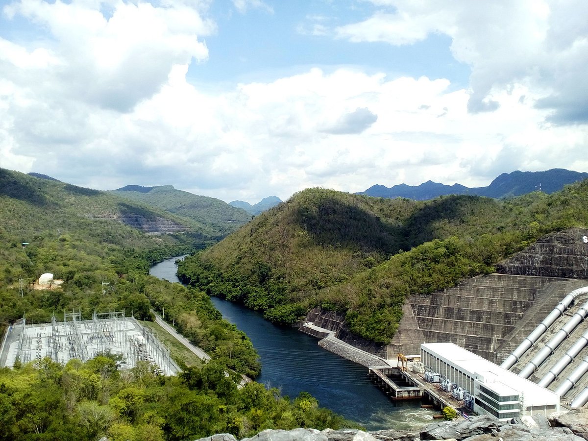 Srinagarind Dam and hydropower station on the Khwae Yai River, with forested mountains of Khuean Srinagarindra National Park beyond