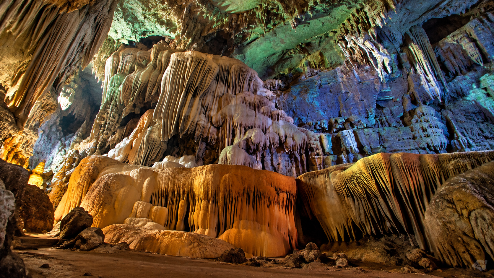 Illuminated limestone chamber with hanging formations and curtains of flowstone at Lam Khlong Ngu National Park, Kanchanaburi