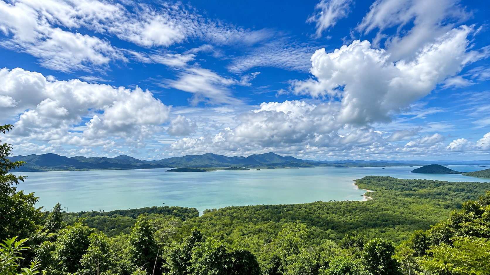Elevated view across mangrove forest toward the Kra Buri River, islands and distant mountains at Lam Nam Kra Buri National Park, Ranong