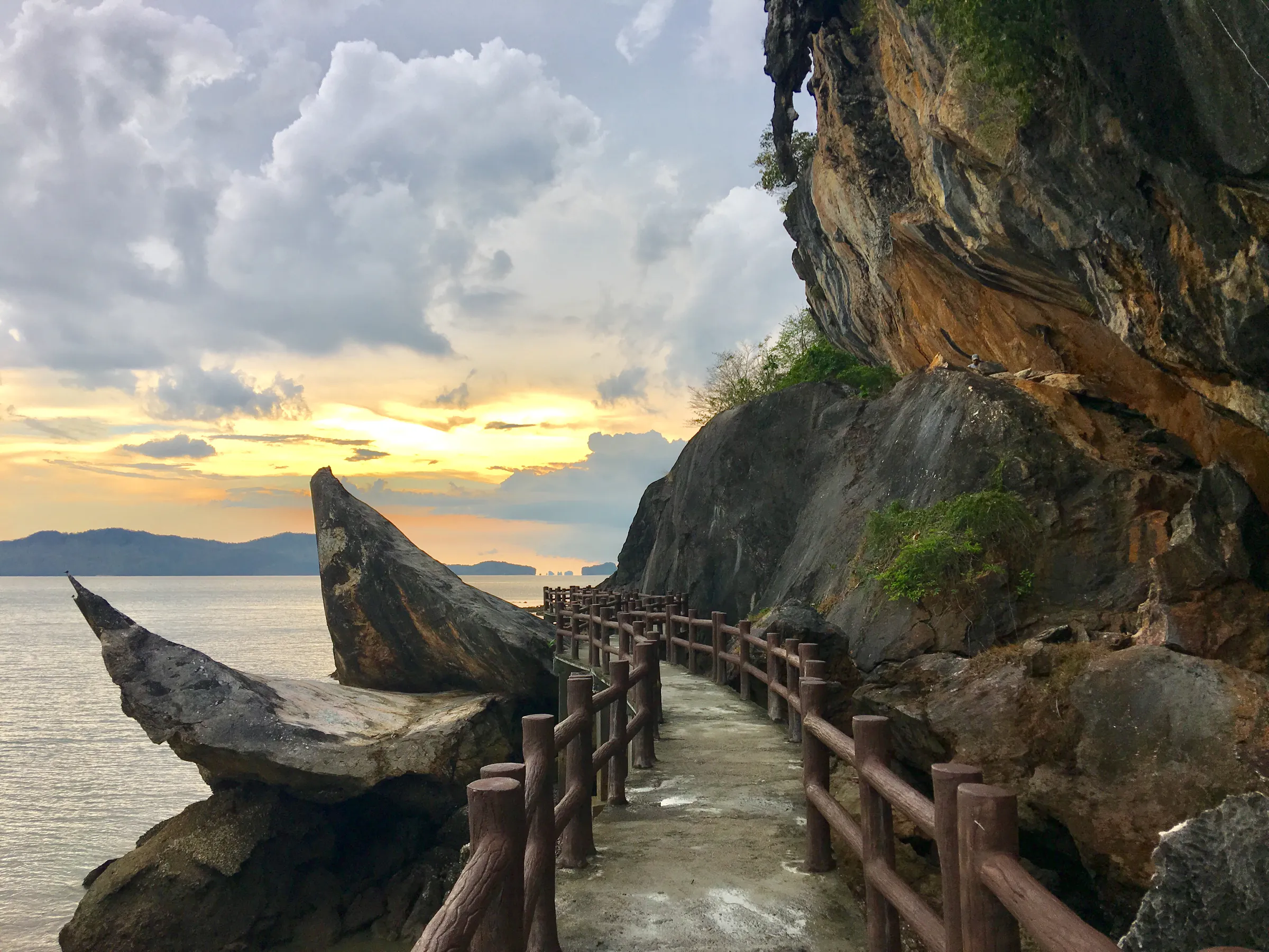 Coastal walkway at Khao To Hong beside limestone cliffs and the Andaman Sea in Mu Ko Phetra National Park