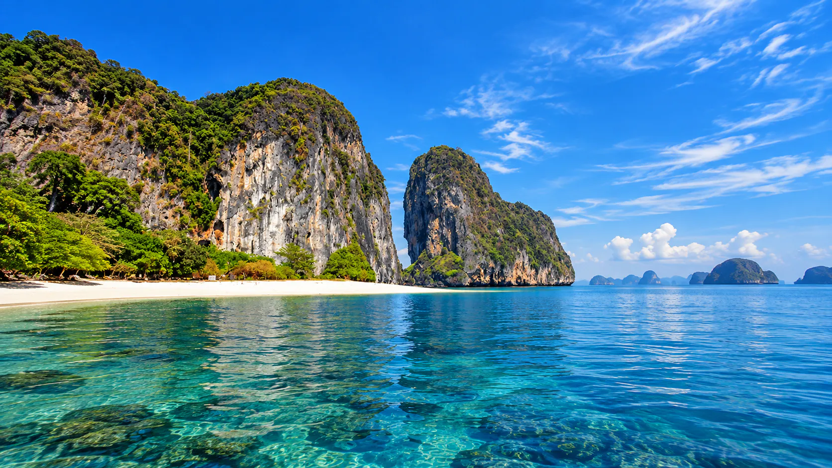 White sand beach, sheer limestone cliffs and scattered islands in Mu Ko Phetra National Park