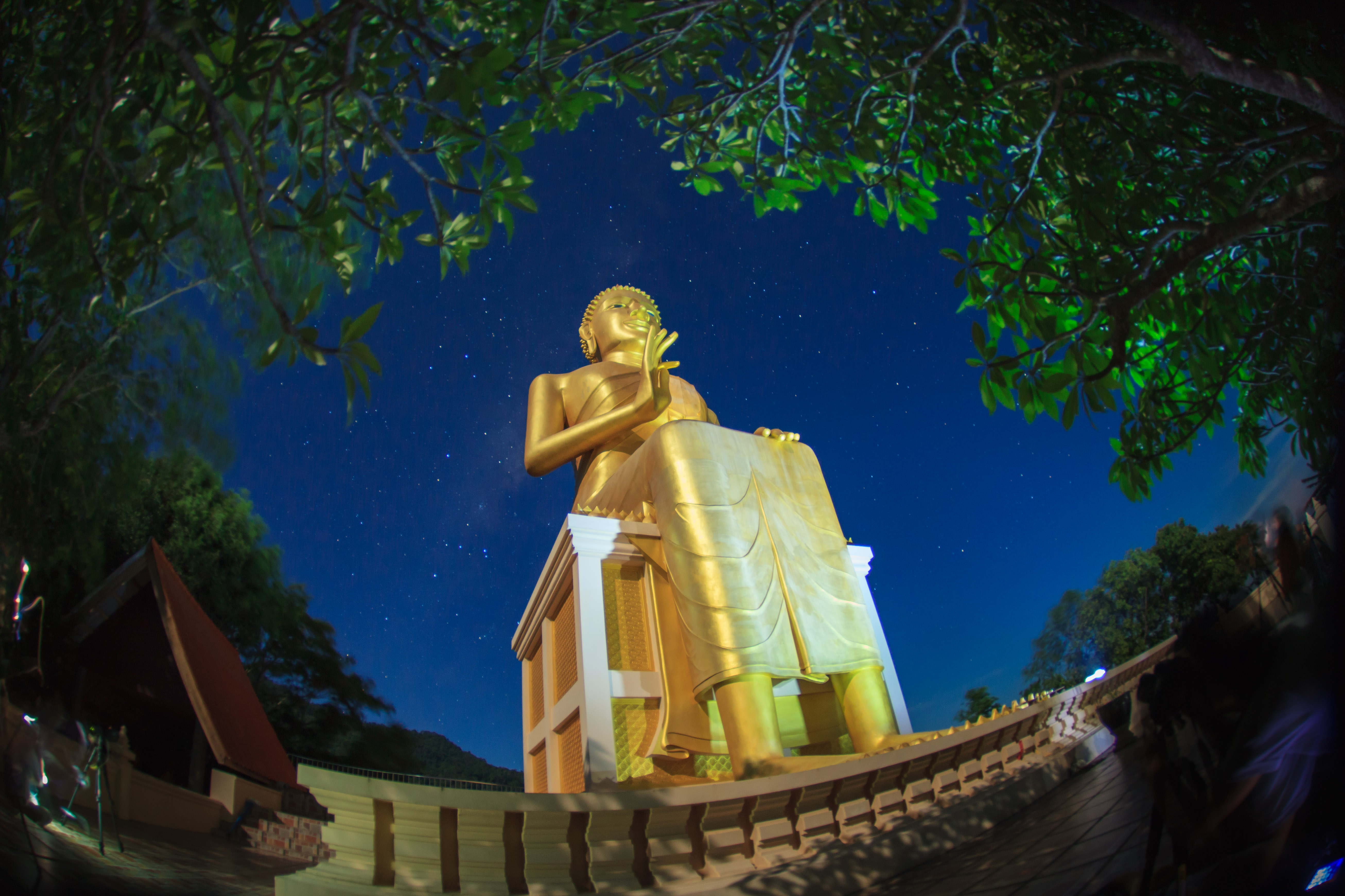 Golden seated Buddha under a starry sky near Khok Pho, in the cultural landscape around Namtok Sai Khao