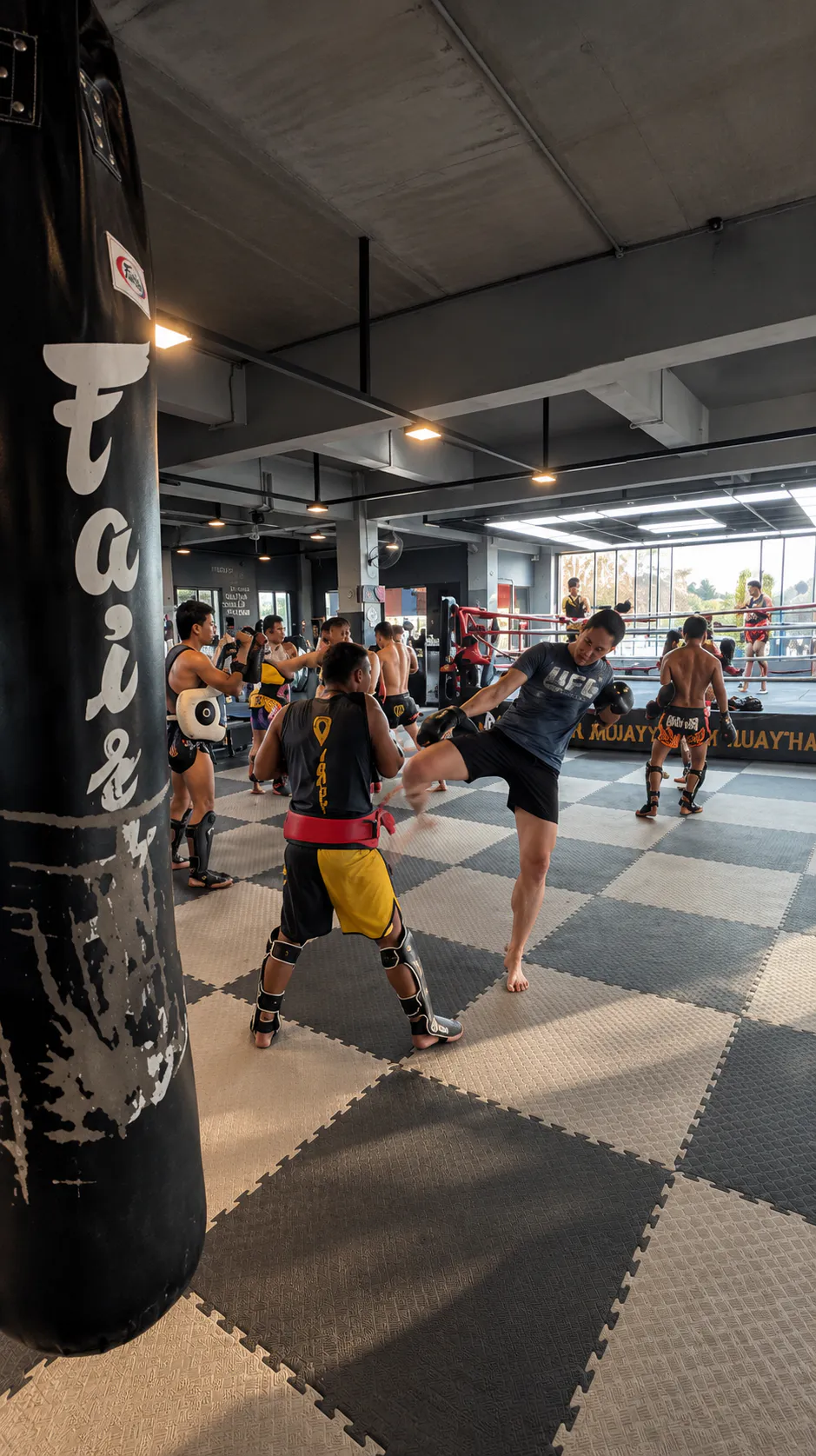 A training class kicking pads at Singhamawin gym